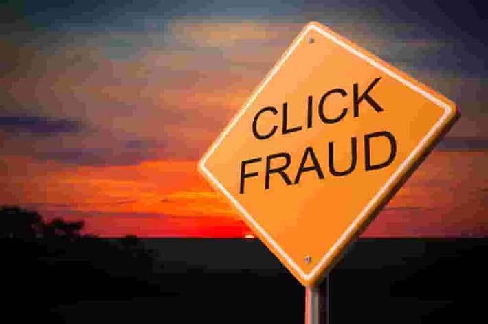 Click Fraud on Warning Road Sign on Sunset Sky Background.-min