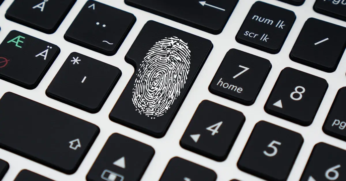 Close-up of a computer keyboard with a fingerprint symbol on the Enter key, representing digital identity, biometric security, or cybersecurity protection.