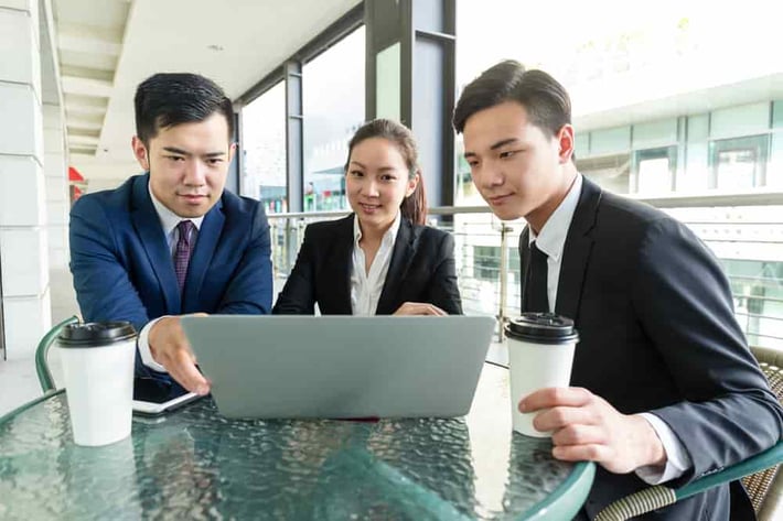 Group of business people discuss about the data showing on laptop computer-min