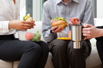 New workers eating sandwiches for lunch