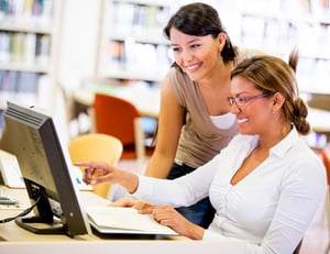 Group of female students working together on a computer