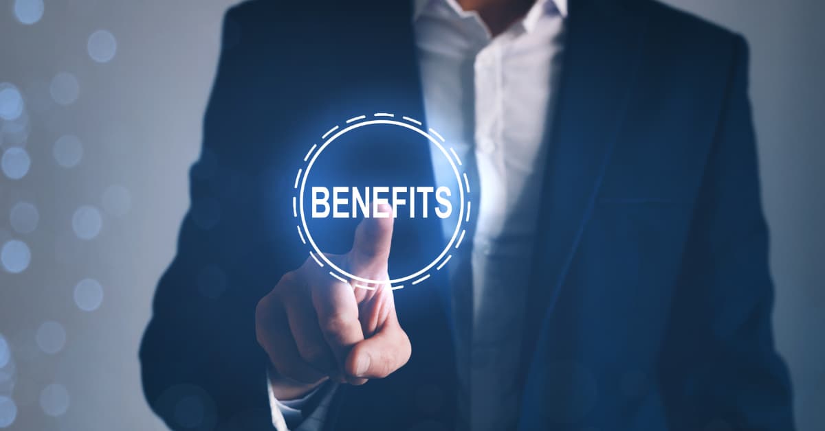Business professional pointing to the word “Benefits,” representing advantages of managed IT services like cost savings, security, and 24/7 support.